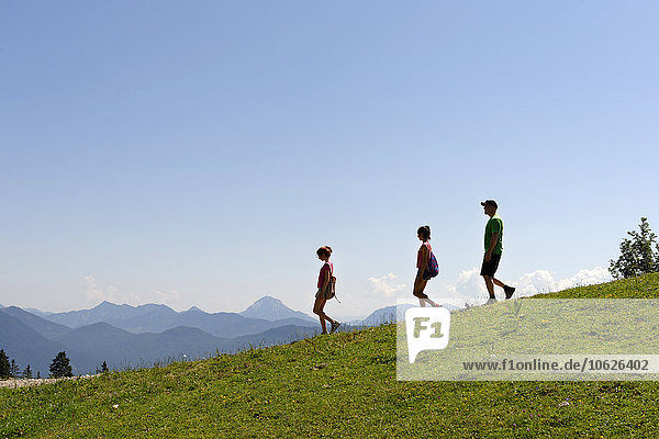 Germany  Bavaria  Lenggries  Father hiking with his daughters at Brauneck mountain