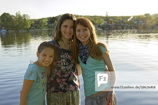 Germany  Mirow  group picture of three girls in front of Lake Mirow