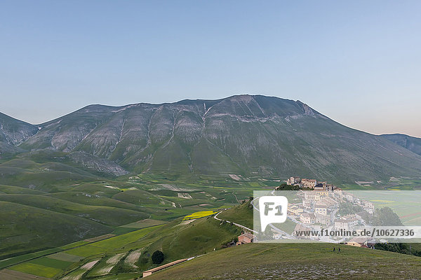 Italy Umbria Monti SIbillini National Park the small town of Castelluccio di Norcia and the Vettore mountain at sunset