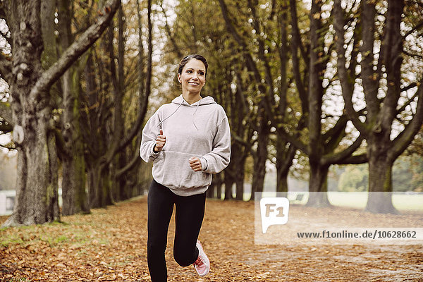 Woman jogging in park during autumn