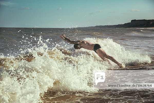 Brazil  Bahia  man jumping into the waves