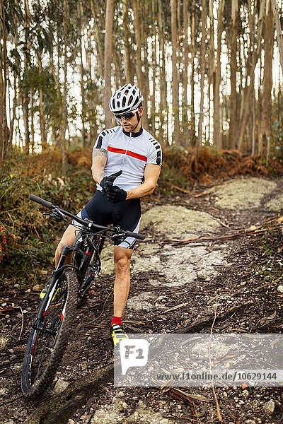 Mountain biker having a rest in the forest