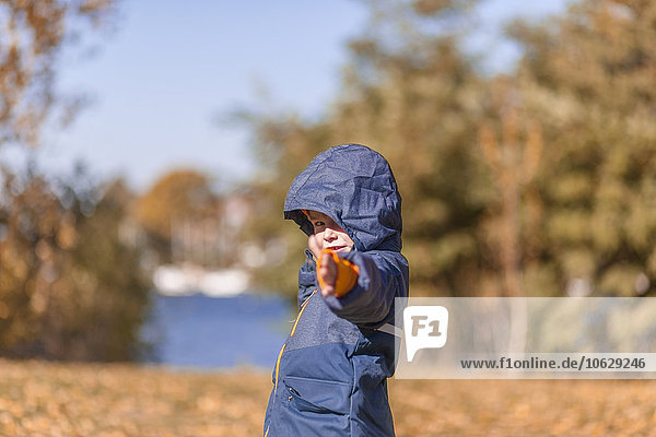 Little boy with rain jacket in the nature