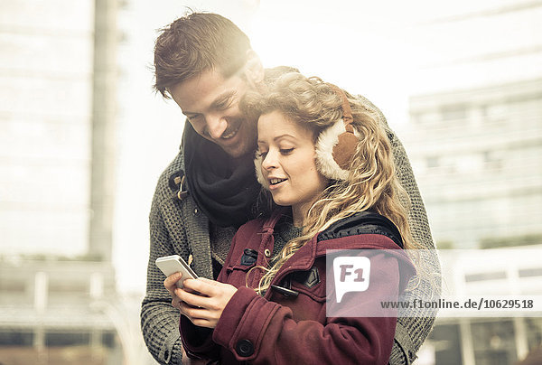 Couple looking together at smartphone