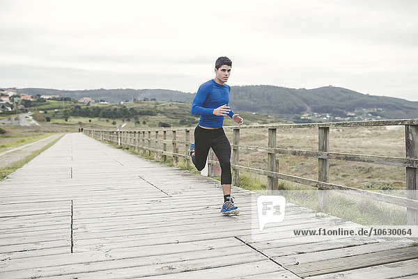 Spain  Ferrol  jogger running on a boardwalk