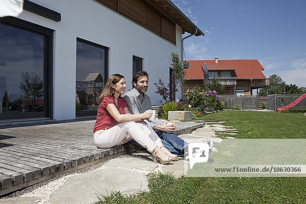 Relaxed couple sitting on terrace