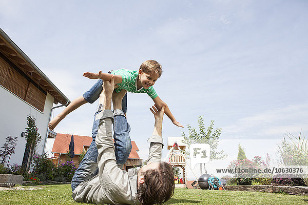 Playful father with son in garden