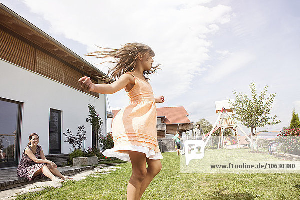 Playful girl with family in garden