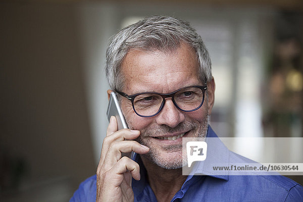 Smiling mature man on cell phone
