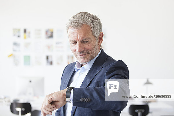 Businessman in office checking the time