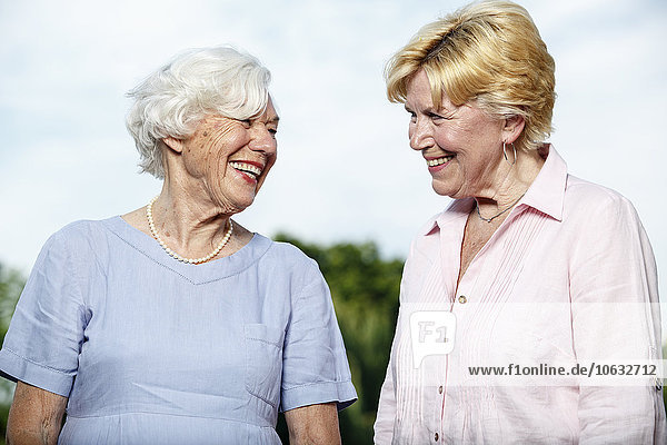 Germany  Berlin  portrait of two laughing senior women
