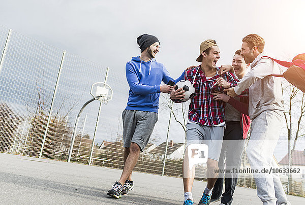 Four young football players
