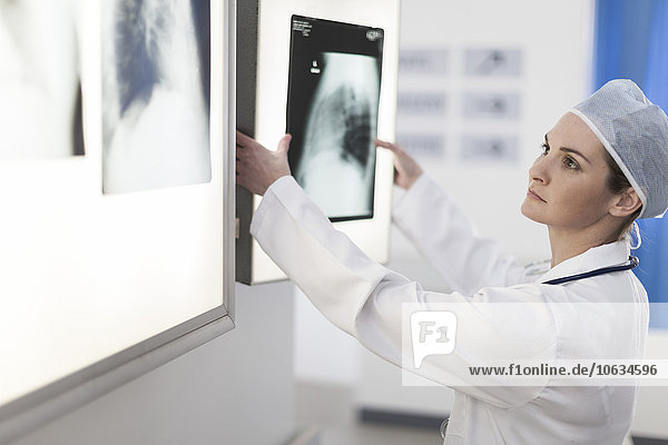 Doctor in hospital  female radiologist looking at x-ray image
