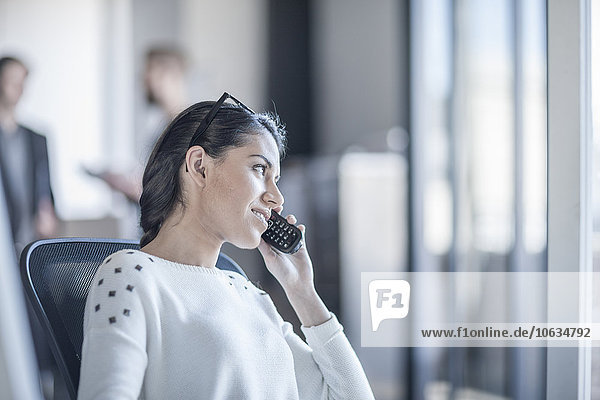 Woman in office talking on the phone