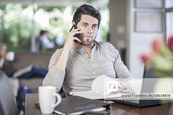 Man sitting at dining room table working at home