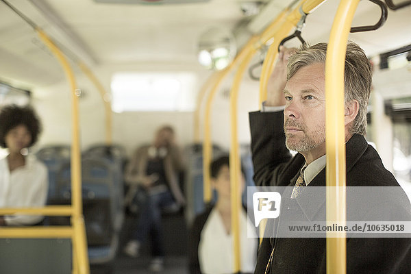Mature man taking city bus