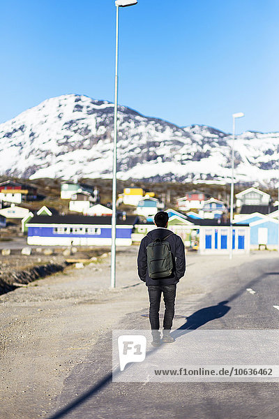 Rear view of man walking on street