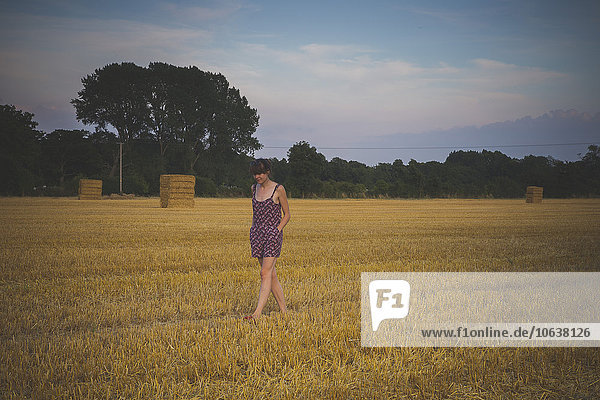 Woman walking on agricultural field