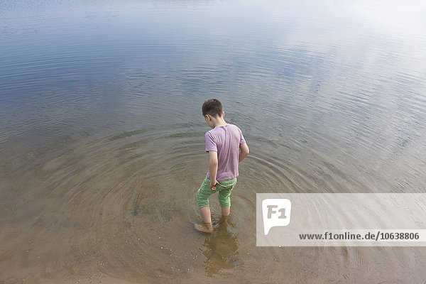 High angle view of boy standing in lake