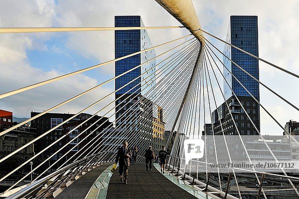 the Zubizuri  tied arch footbridge across the Nervion River  designed by architect Santiago Calatrava  with  in the background  the Isozaki Atea twin towers designed by Japanese architect Arata Isozaki  Bilbao  province of Biscay  Basque Country  Spain  Europe.