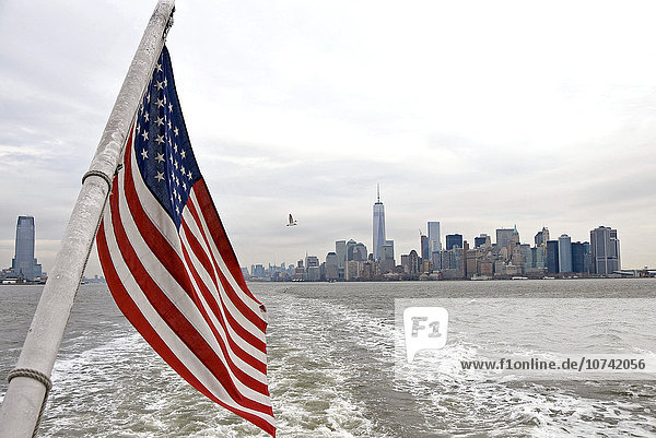 USA  New York  american flag and Manhattan cityscape