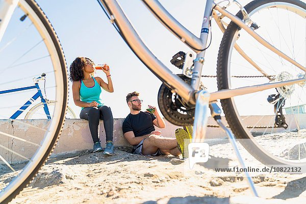 Couple relaxing after bike ride  bicycles beside them