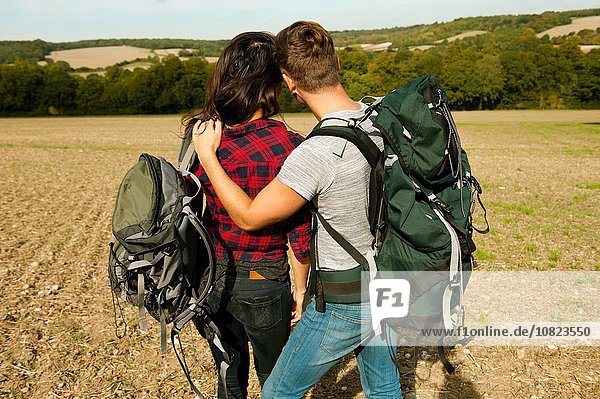Rear view of romantic young hiking couple in field  Great Missenden  Buckinghamshire  U.K