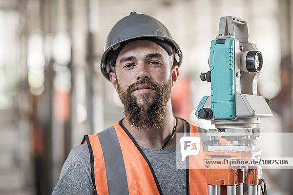 Portrait of young male surveyor on construction site
