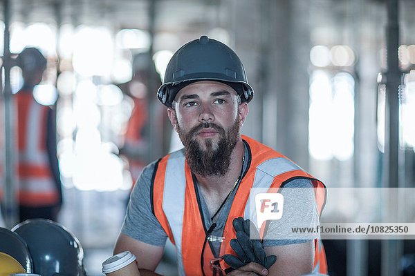 Builder taking a coffee break on construction site