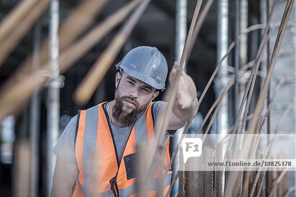Site manager signaling with hand on construction site