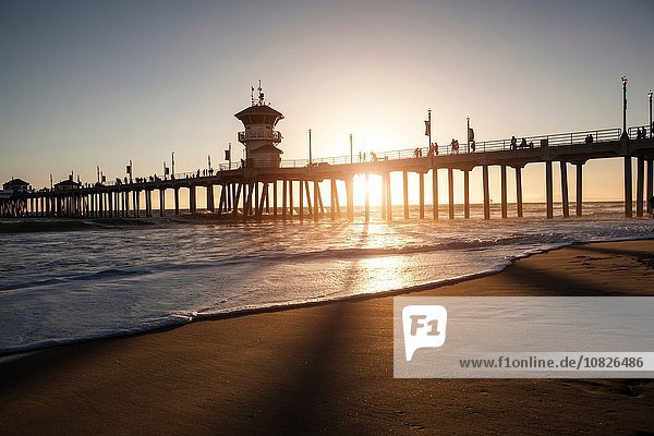 Silhouetted view of pier at sunset  Huntington Beach  California  USA
