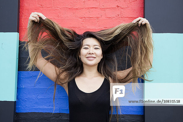 Asian woman playing with hair