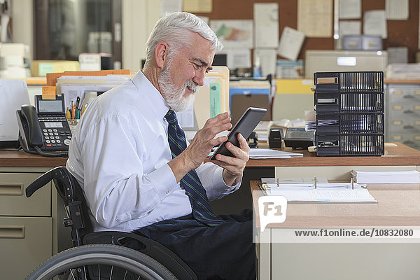 Caucasian businessman using digital tablet in office