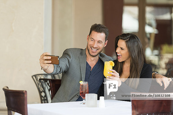 Couple taking selfie in restaurant