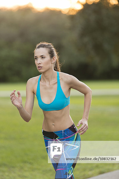 Mixed race woman jogging on road