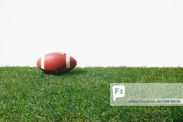American football ball on grass