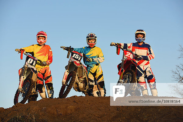 Motocross bikers on dirt track
