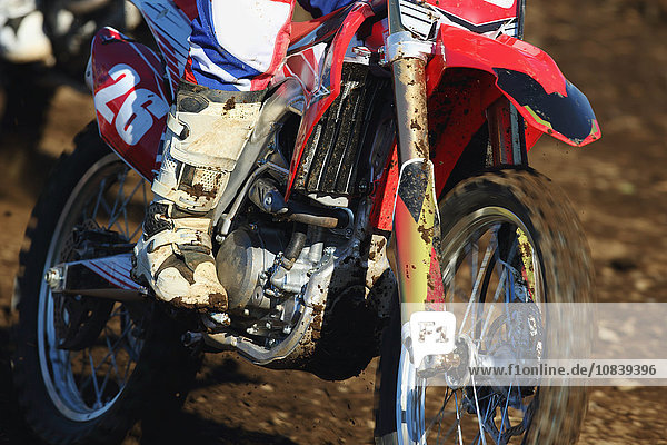 Motocross biker on dirt track