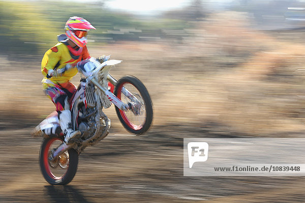 Motocross biker on dirt track