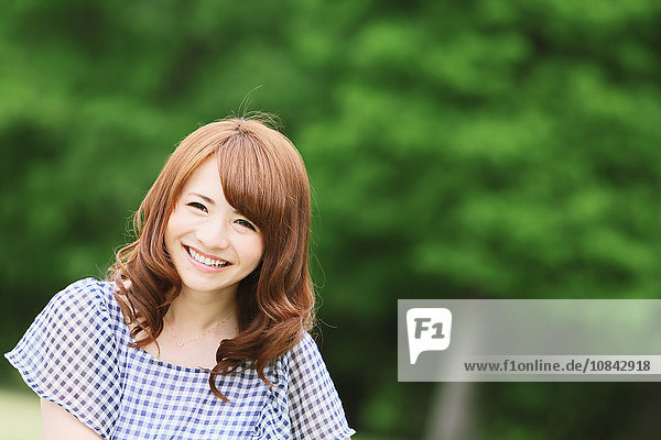 Young attractive Japanese woman in a city park