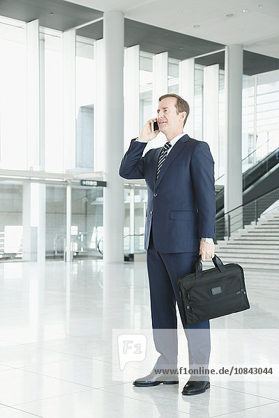 Caucasian businessman on the phone in modern office