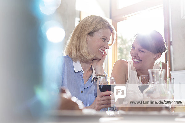 Smiling women drinking wine