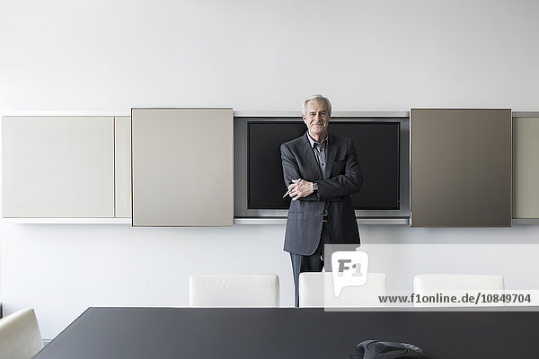 Portrait confident senior businessman in conference room