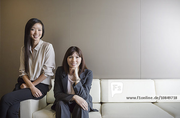 Portrait confident businesswomen on sofa