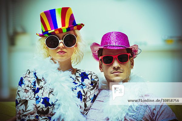 Portrait attitude couple wearing costume hats and sunglasses