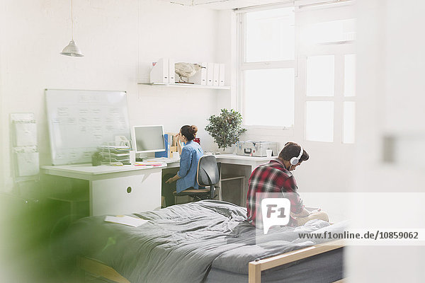 Young adults studying in apartment