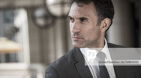 Close up pensive corporate businessman looking away