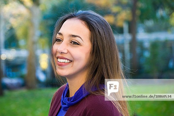 Happy young woman in park
