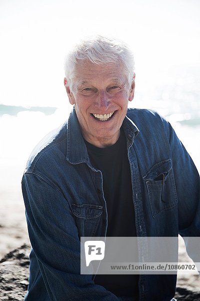 Porträt eines älteren Mannes am Strand  lächelnd