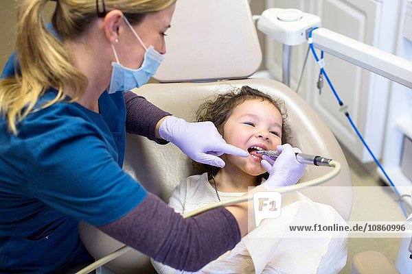Mädchen auf Zahnarztstuhl bei zahnärztlicher Untersuchung
